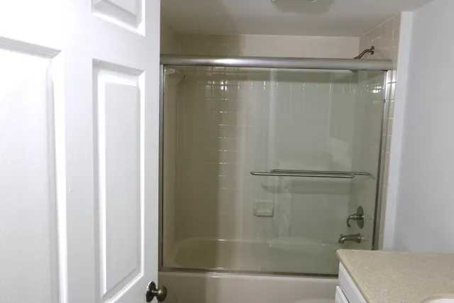 a bathroom with a glass shower door
