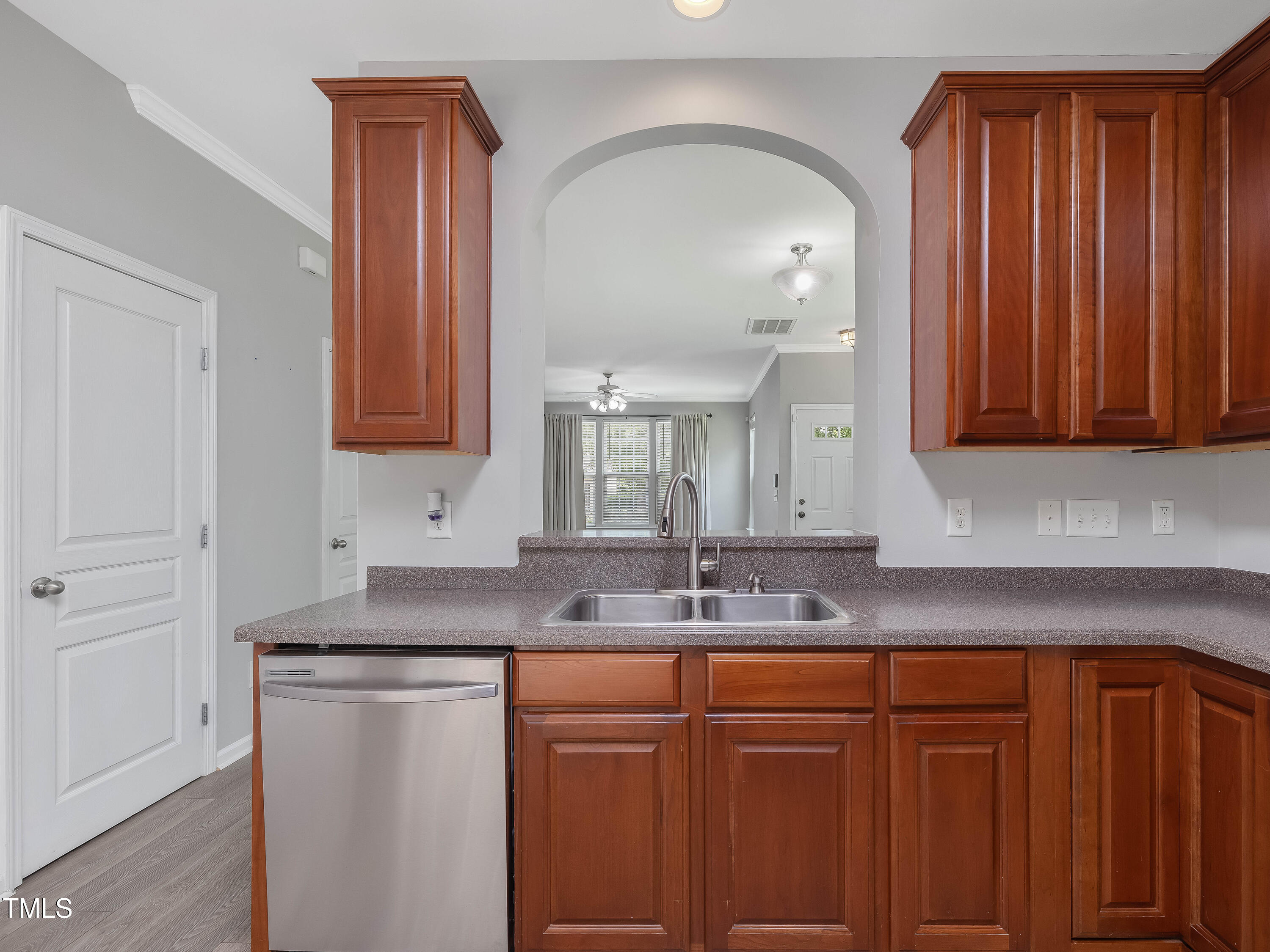 7661 Winners Edge Street Raleigh, NC 27617 - Photo 5 of 13 a kitchen with stainless steel appliances granite countertop a sink cabinets and wooden floor