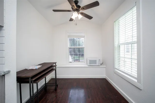a view of a workspace with furniture and a window