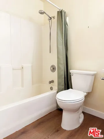 a bathroom with a toilet and a bathtub