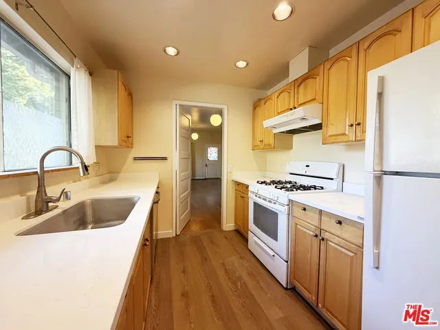 a kitchen with a sink stove and refrigerator