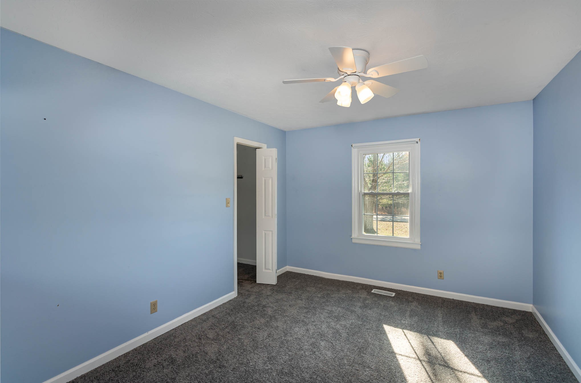 1035 Garton Road Burns, TN 37029 - Photo 20 of 31 a view of an empty room with window and chandelier fan