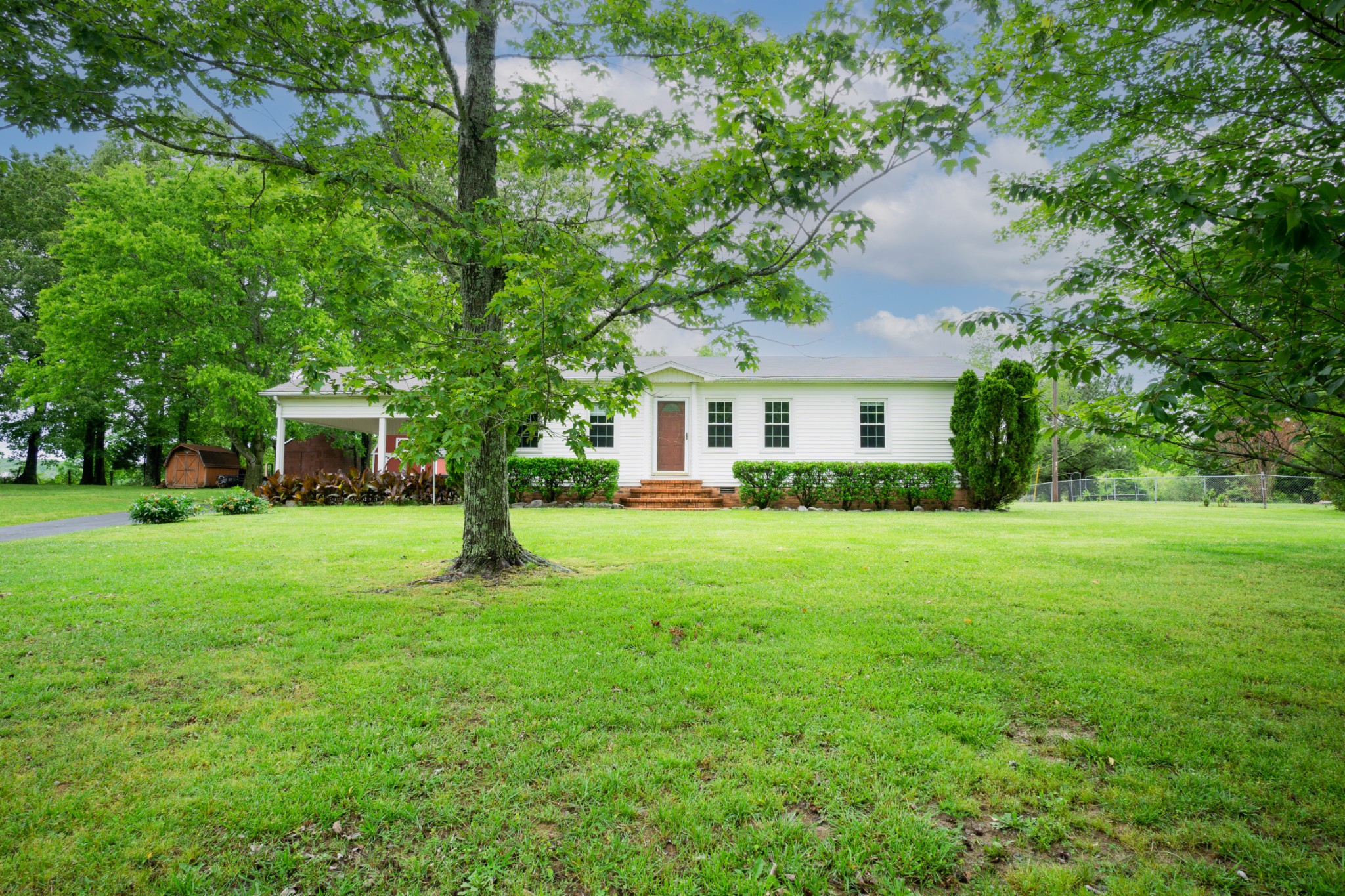 1035 Garton Road Burns, TN 37029 - Photo 2 of 31 a front view of a house with a garden