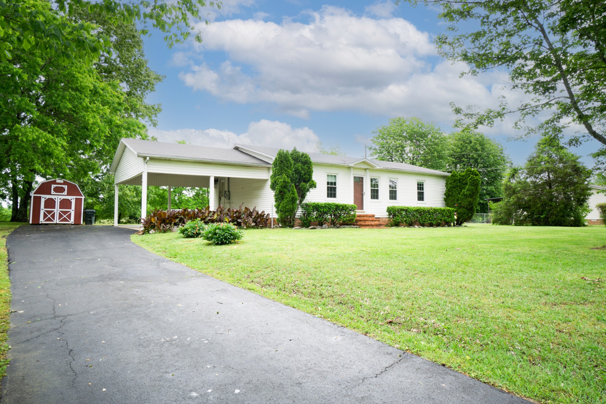 1035 Garton Road Burns, TN 37029 - Photo 3 of 31 a front view of a house with a yard and potted plants