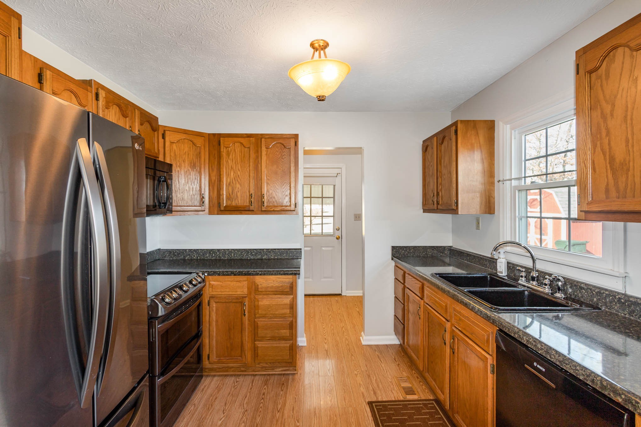 1035 Garton Road Burns, TN 37029 - Photo 7 of 31 a kitchen with stainless steel appliances granite countertop a refrigerator a sink and white cabinets