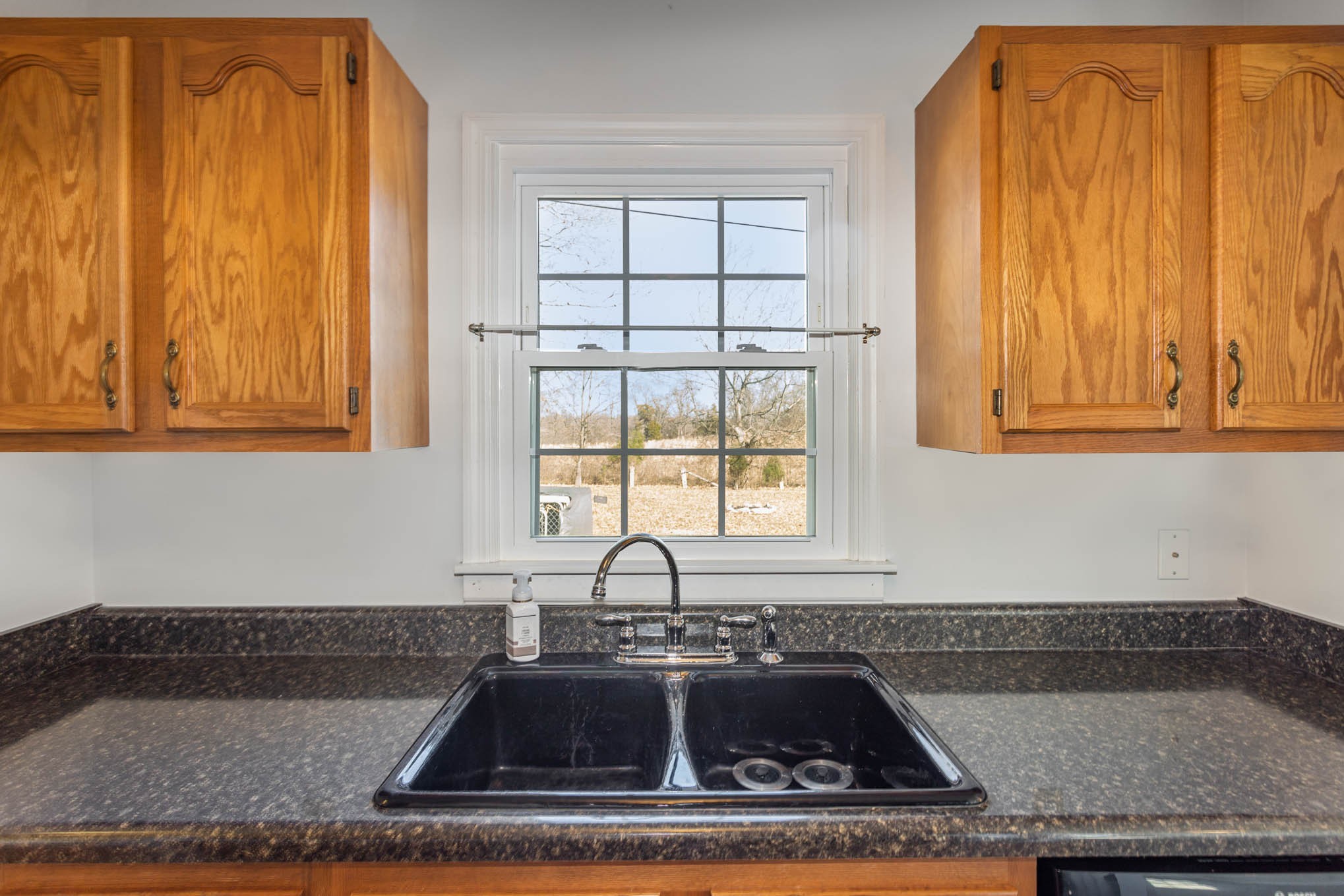 1035 Garton Road Burns, TN 37029 - Photo 8 of 31 a kitchen with granite countertop a sink and a window