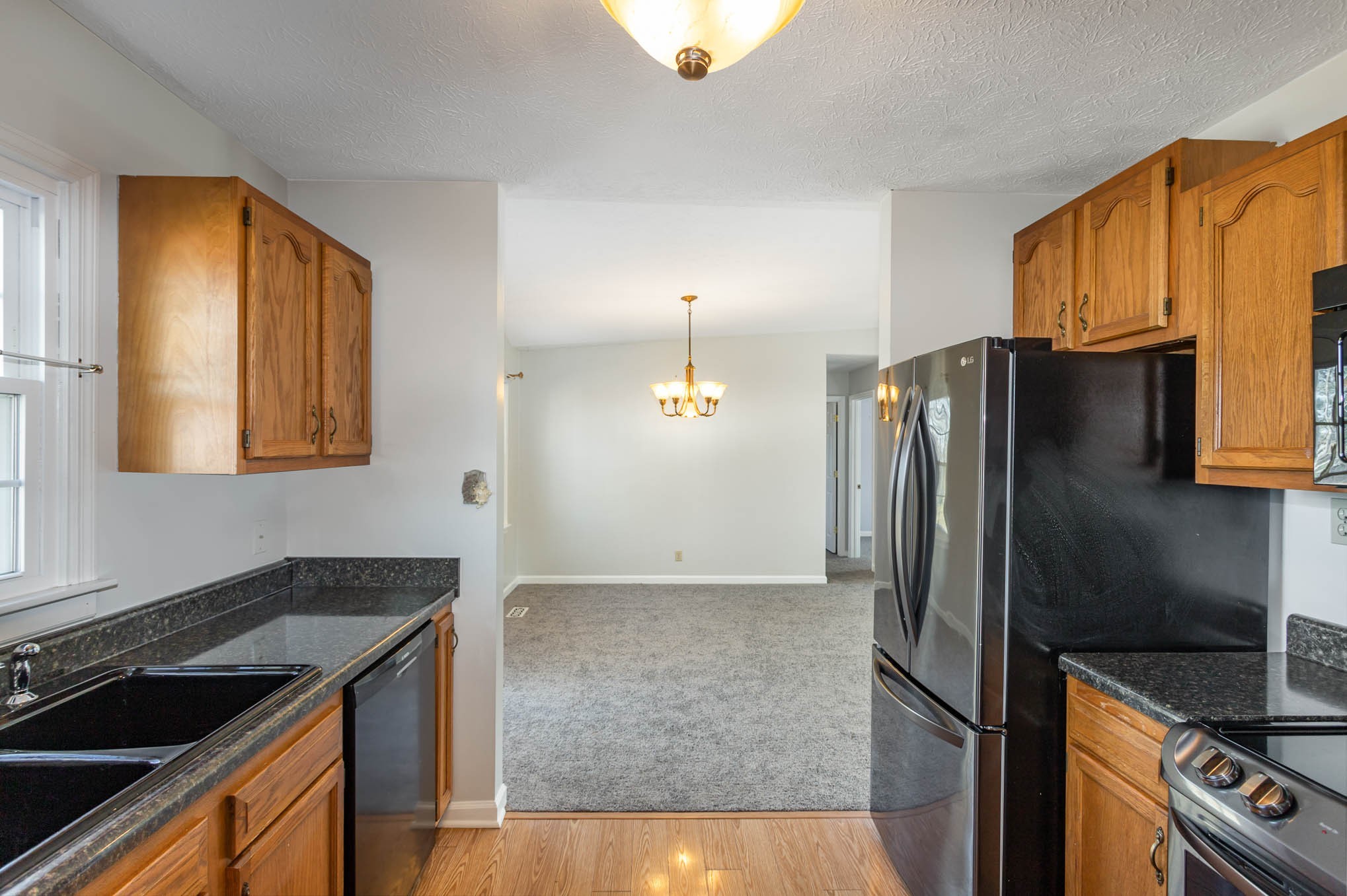1035 Garton Road Burns, TN 37029 - Photo 9 of 31 a kitchen with stainless steel appliances granite countertop a refrigerator and a stove