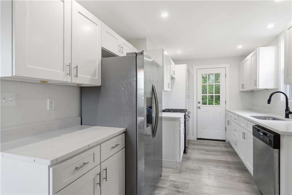 480 Songo Street Pittsburgh, PA 15227 - Photo 14 of 36 a kitchen with white cabinets and stainless steel appliances