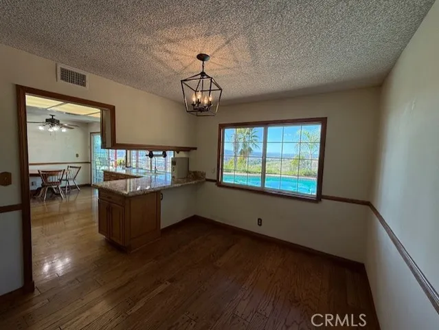 a view of a workspace with furniture and a chandelier