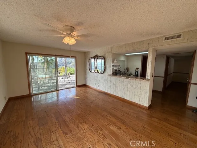 a bedroom with a large bed and a flat tv screen on dresser
