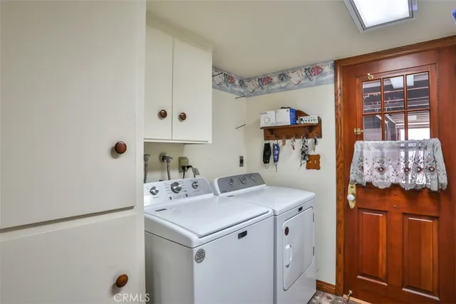 a bathroom with a double vanity sink a mirror and a bathtub