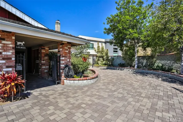 a view of a room with wooden floor water heater and a window