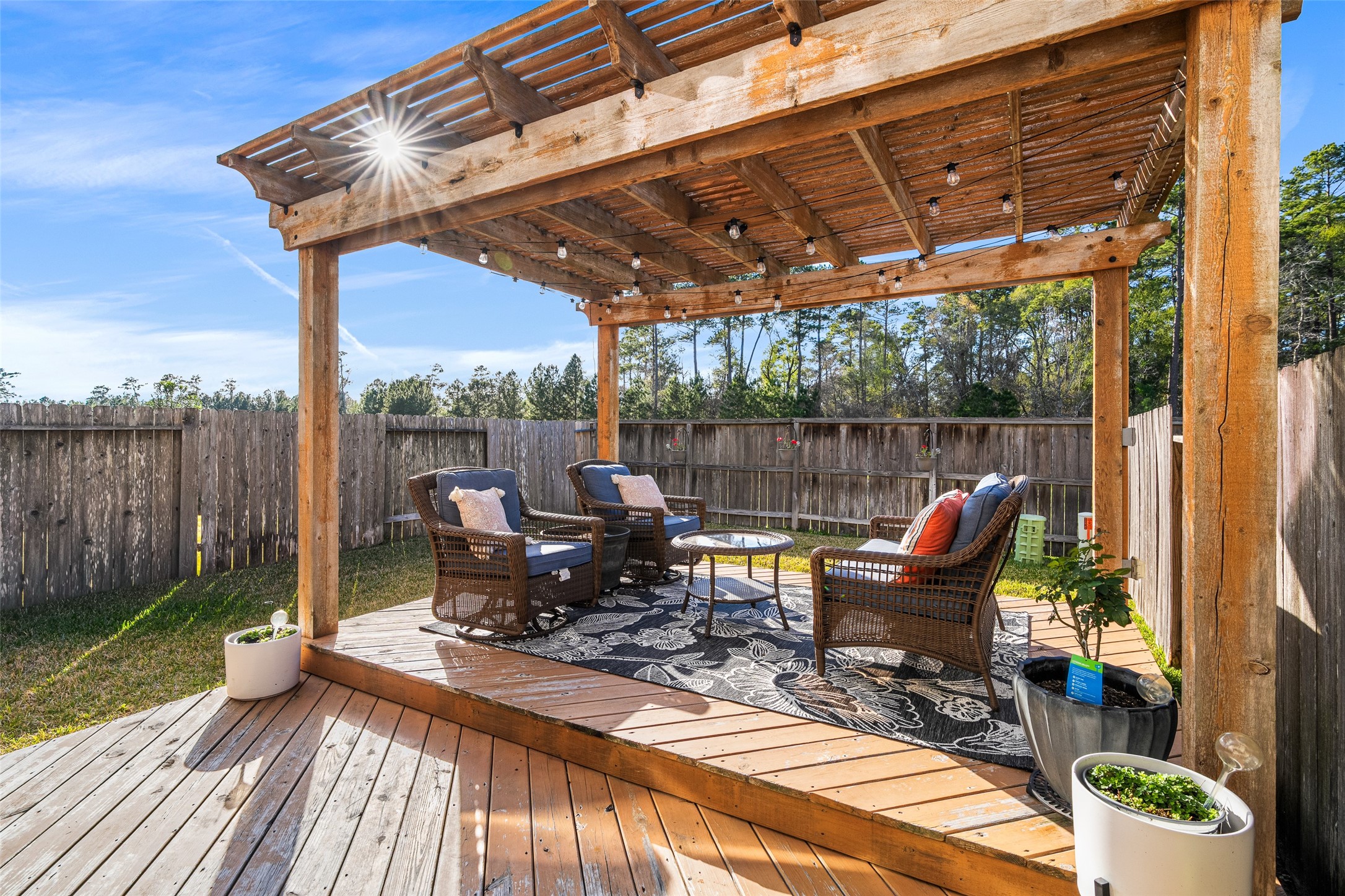 267 Bloomhill Place Magnolia, TX 77354 - Photo 14 of 19 Step into a stunning backyard retreat featuring a custom-built wooden deck and a beautiful wooden gazebo, offering the perfect setting for entertaining guests, relaxing outdoors, or enjoying quiet evenings in a private, serene environment.