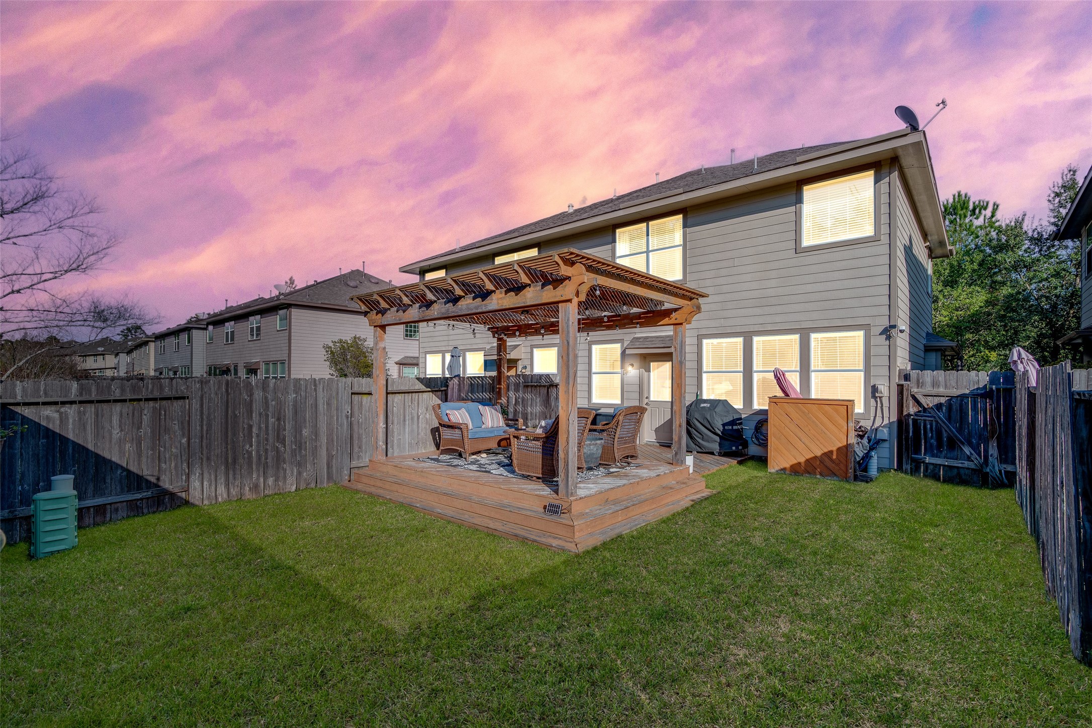 267 Bloomhill Place Magnolia, TX 77354 - Photo 15 of 19 Enjoy this fenced-in backyard with a well-maintained lawn and a cozy patio, perfect for outdoor gatherings, relaxing in the sun, or creating your own garden oasis.