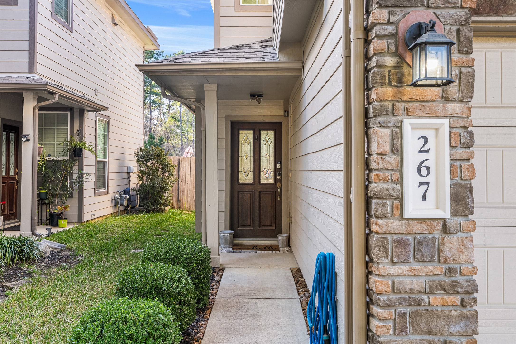 267 Bloomhill Place Magnolia, TX 77354 - Photo 2 of 19 A stunning dark-stained front door with a glass design sets the tone for this home’s charm and timeless appeal.