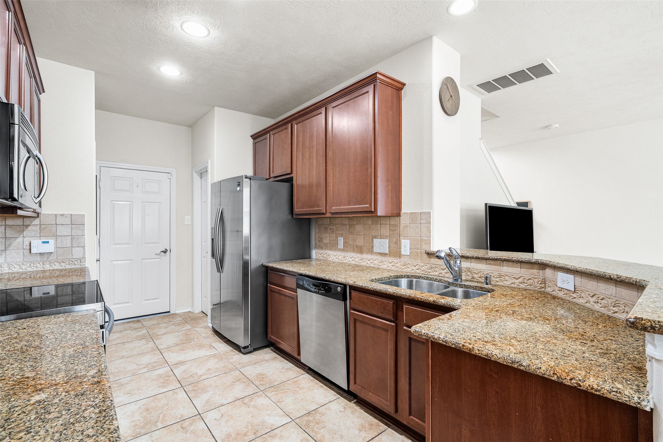 267 Bloomhill Place Magnolia, TX 77354 - Photo 5 of 19 The kitchen also features stainless steel appliances, granite counter-tops and recessed lighting, offering a perfect blend of functionality and style for cooking and entertaining.