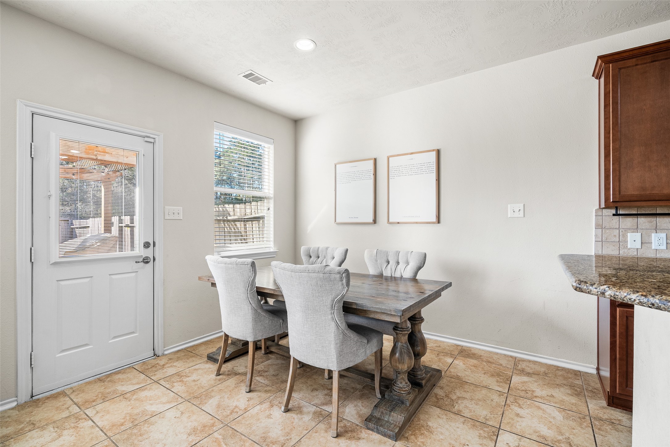 267 Bloomhill Place Magnolia, TX 77354 - Photo 6 of 19 Enjoy a bright and inviting breakfast area complete with a large window with privacy blinds, tile flooring, and recessed lighting.