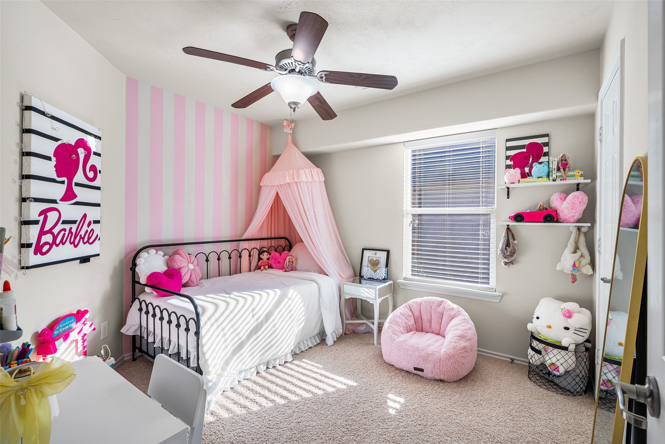 267 Bloomhill Place Magnolia, TX 77354 - Photo 10 of 19 The bedroom features soft carpeting, a classic ceiling fan, and a window with privacy blinds, creating a comfortable and inviting retreat.