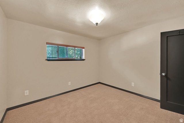 655 Ogden Canyon Road Ogden, UT 84401 - Photo 23 of 50 Neutral wall tones define this room, featuring a window with integrated blinds and a wood-finish valance