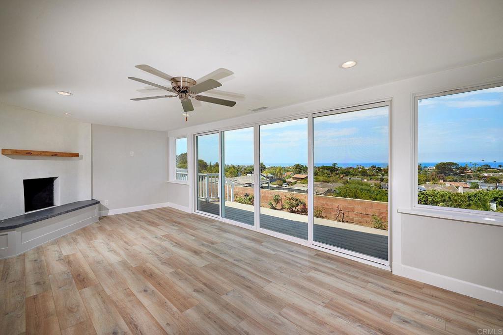 717 Barbara Avenue Solana Beach, CA 92075 - Photo 16 of 40 an empty room with floor to ceiling windows and ceiling fan
