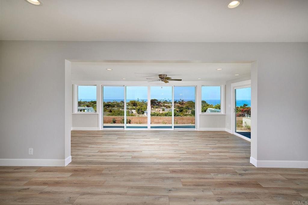 717 Barbara Avenue Solana Beach, CA 92075 - Photo 22 of 40 a view of an empty room with wooden floor and a window