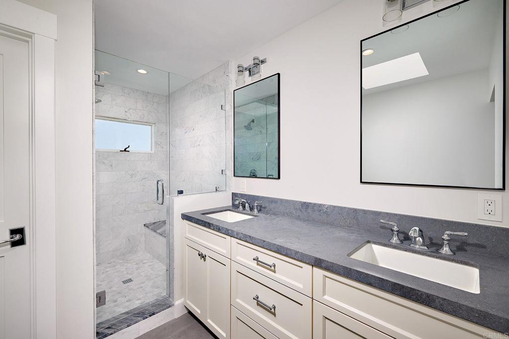 717 Barbara Avenue Solana Beach, CA 92075 - Photo 30 of 40 a bathroom with a sink and a mirror