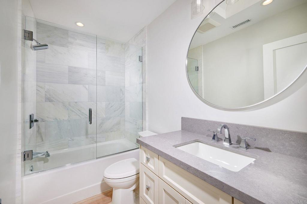 717 Barbara Avenue Solana Beach, CA 92075 - Photo 35 of 40 a bathroom with a granite countertop sink a toilet and a mirror
