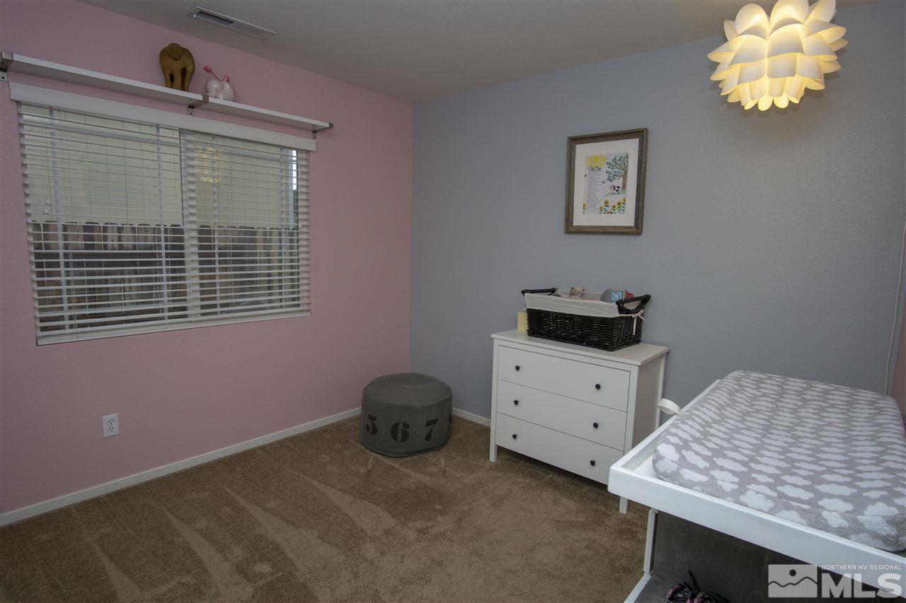 7692 Corso Street Reno, NV 89506 - Photo 14 of 23 a bedroom with a bed and a window