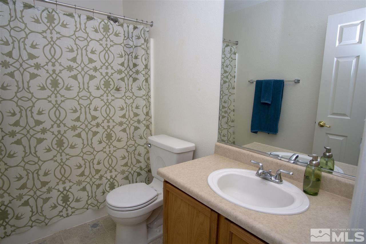 7692 Corso Street Reno, NV 89506 - Photo 17 of 23 a bathroom with a sink and a toilet