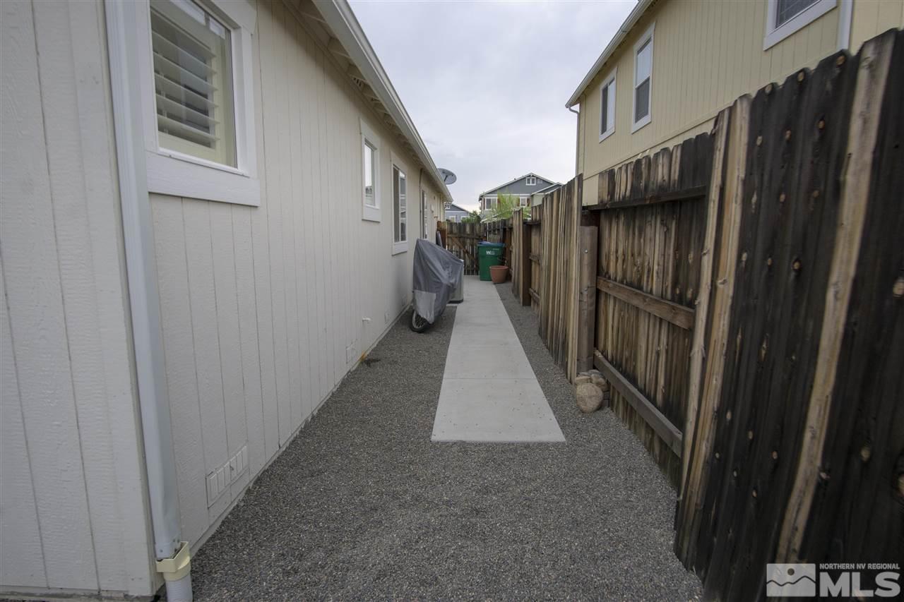 7692 Corso Street Reno, NV 89506 - Photo 21 of 23 a view of a pathway of a house with wooden fence