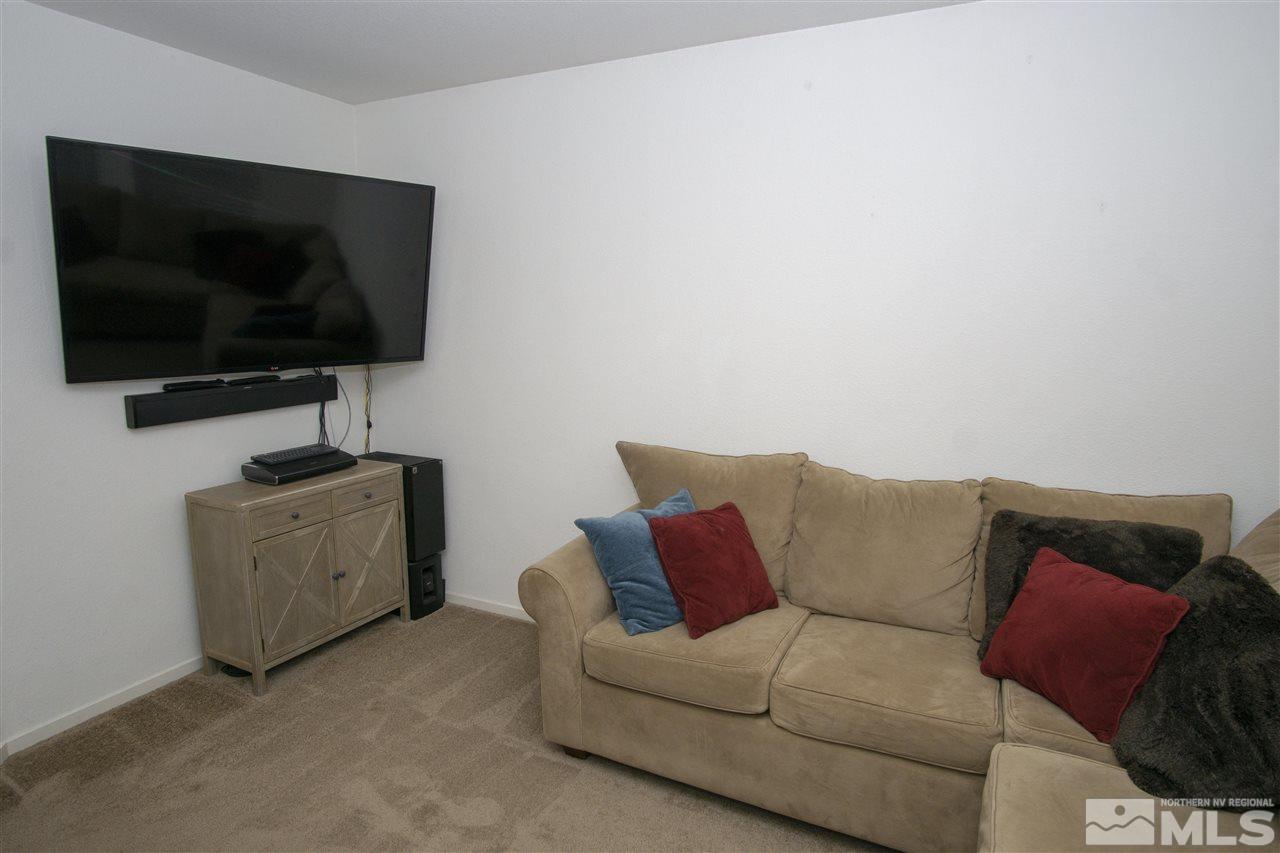 7692 Corso Street Reno, NV 89506 - Photo 5 of 23 a living room with furniture and a flat screen tv