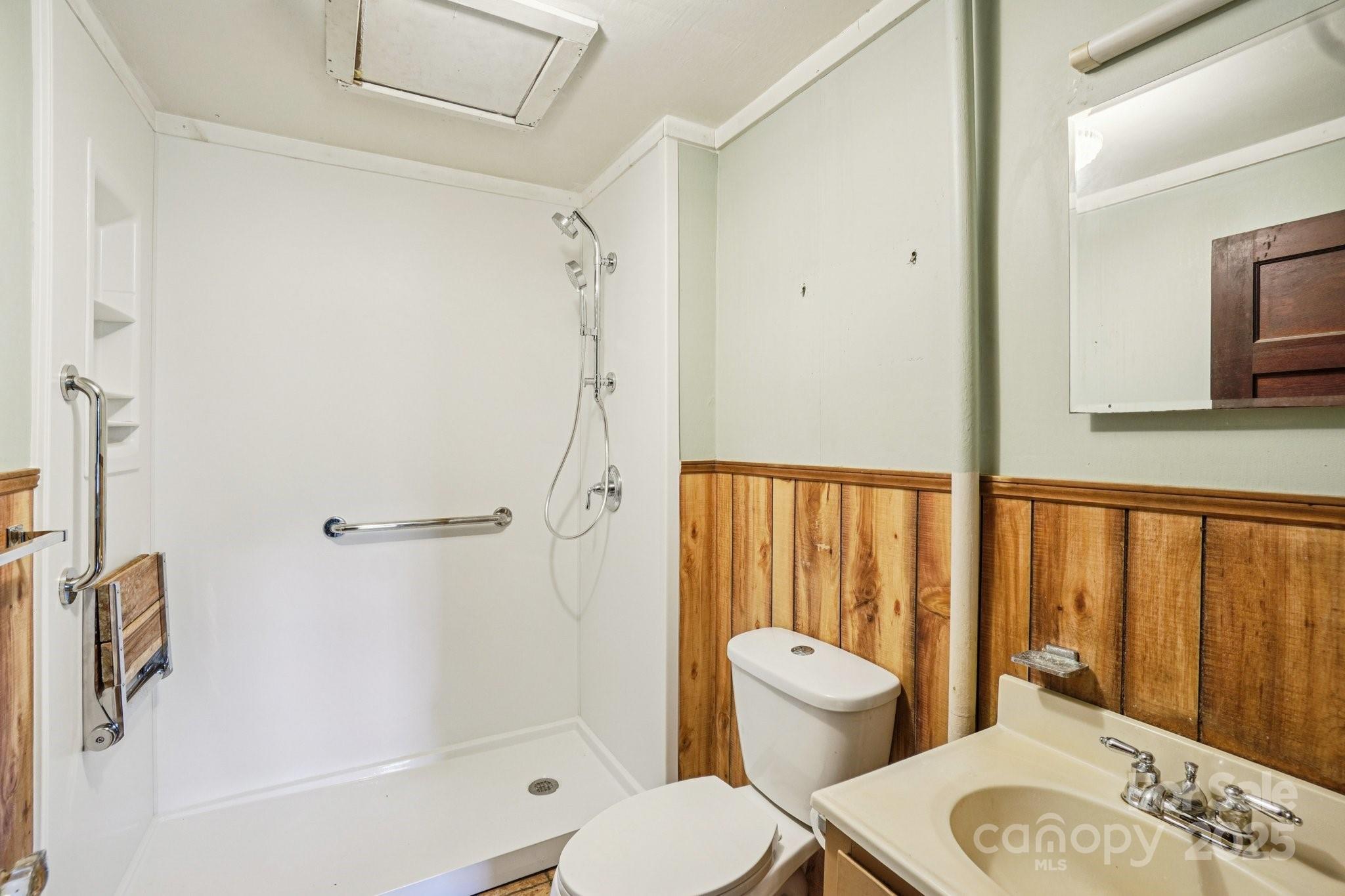 203 North Beaverdam Road Candler, NC 28715 - Photo 15 of 40 a bathroom with a toilet and a shower
