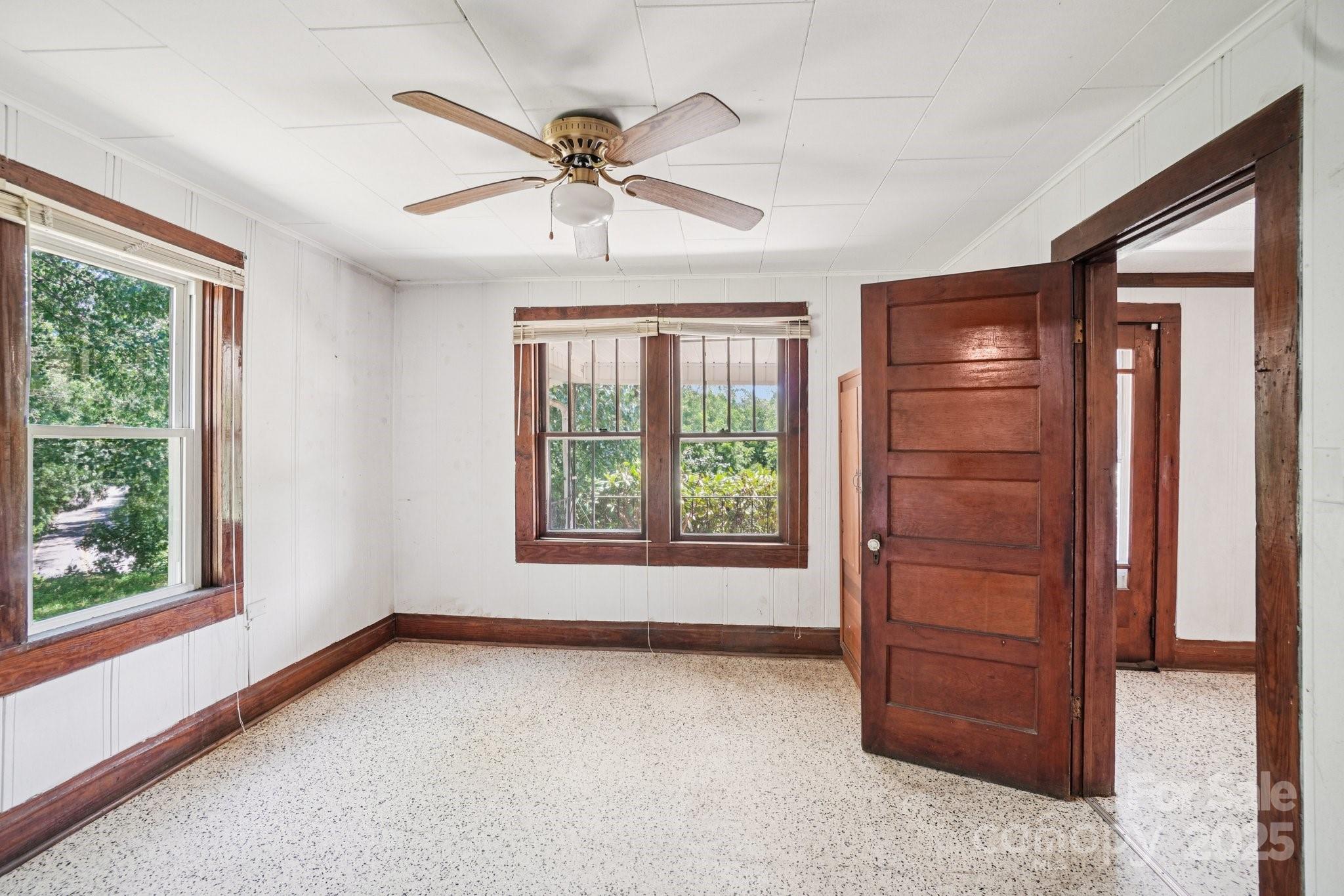203 North Beaverdam Road Candler, NC 28715 - Photo 19 of 40 an empty room with windows closet and fan