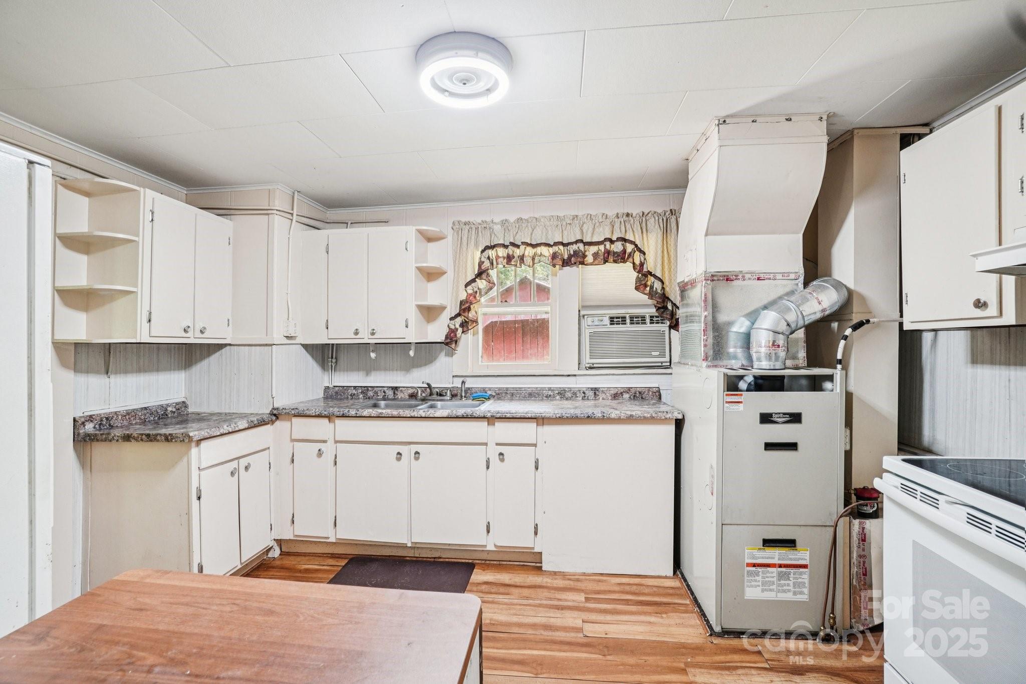 203 North Beaverdam Road Candler, NC 28715 - Photo 21 of 40 a kitchen with cabinets and window