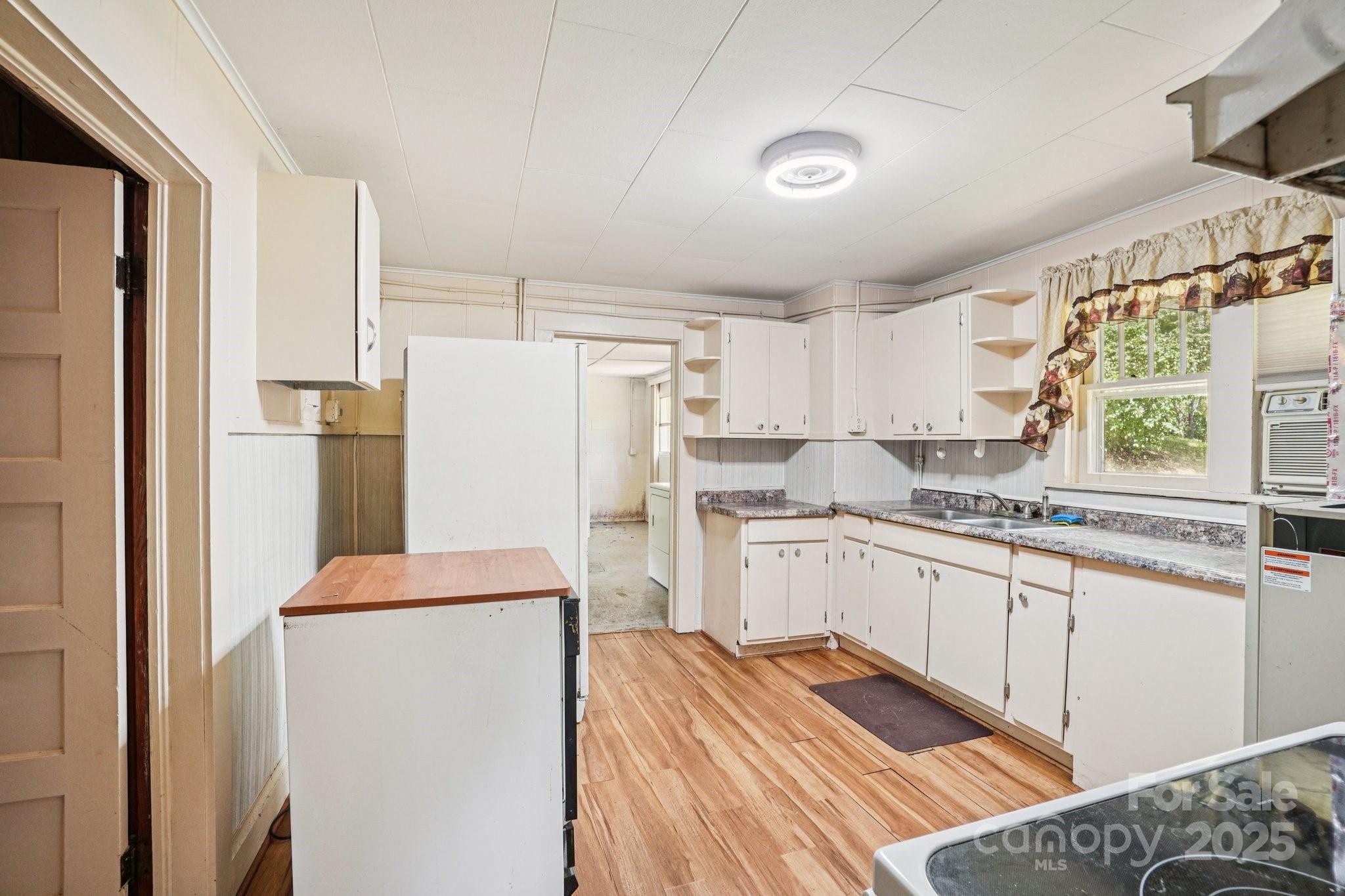 203 North Beaverdam Road Candler, NC 28715 - Photo 22 of 40 a kitchen with a refrigerator sink and stove