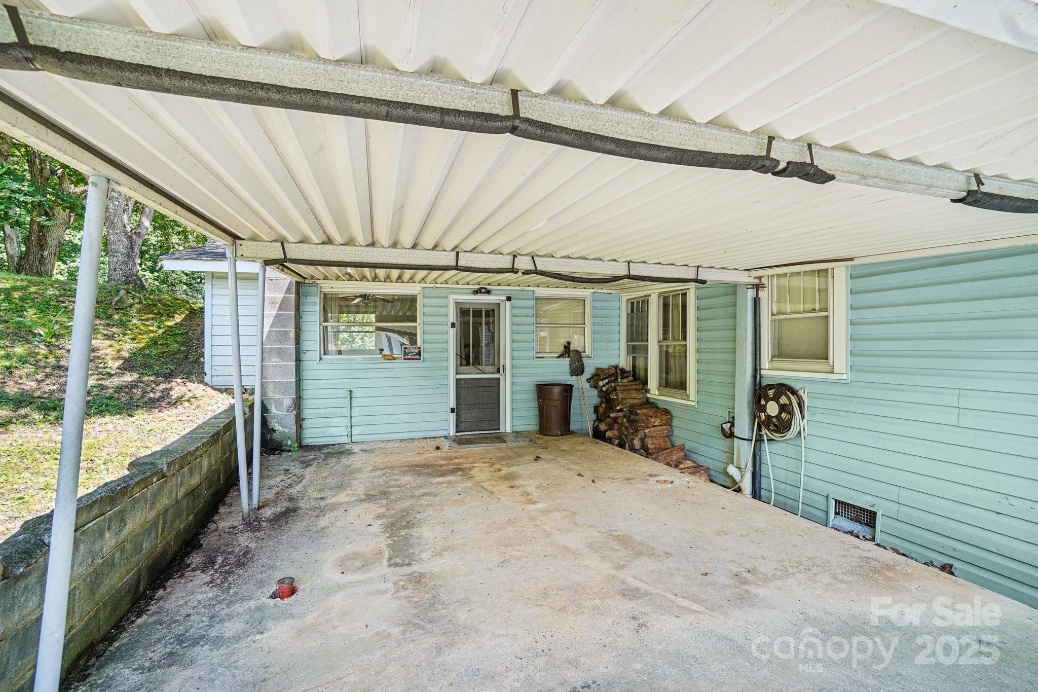 203 North Beaverdam Road Candler, NC 28715 - Photo 28 of 40 a view of a porch with furniture and front door