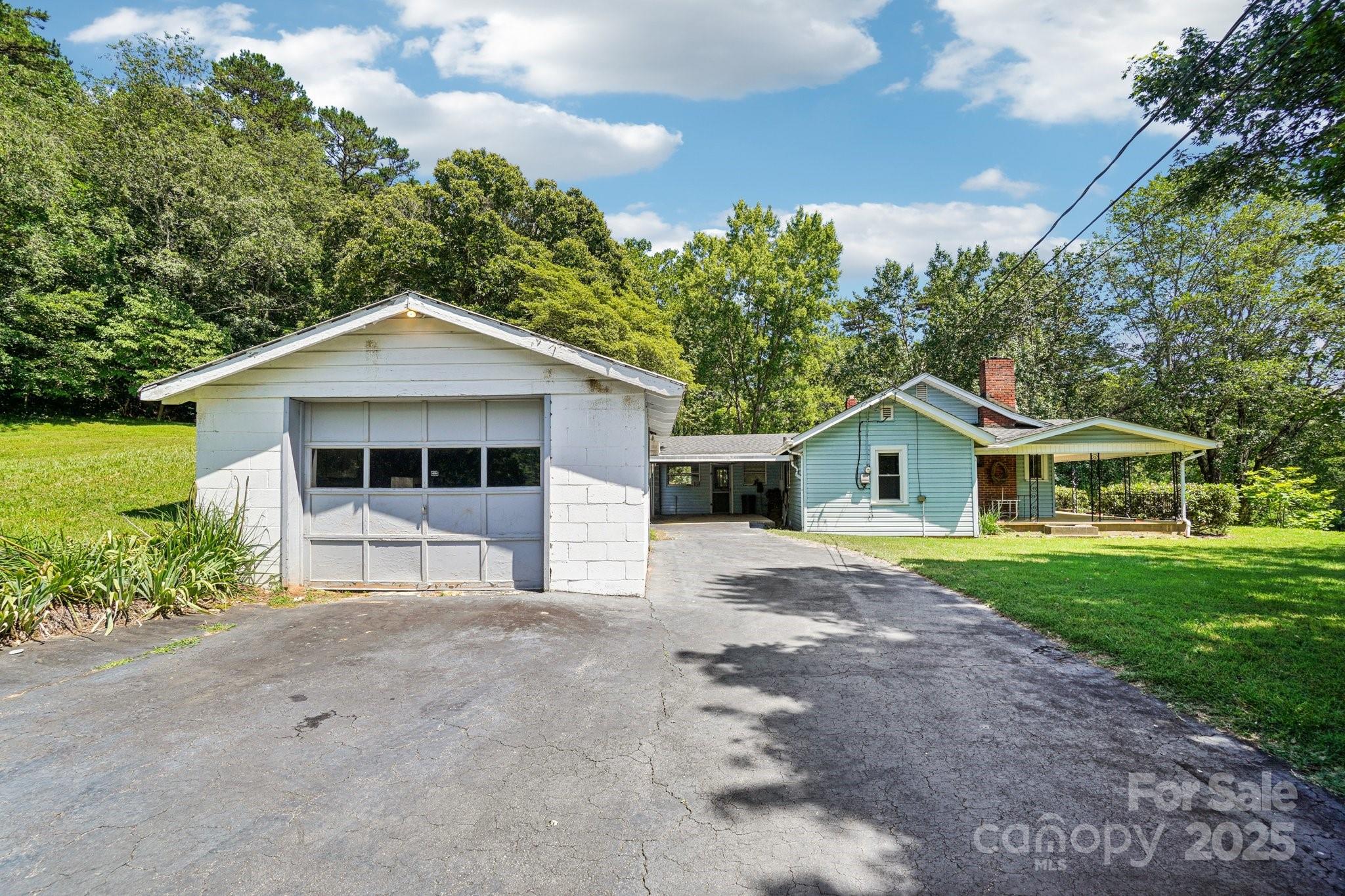 203 North Beaverdam Road Candler, NC 28715 - Photo 29 of 40 a front view of a house with a yard and garage