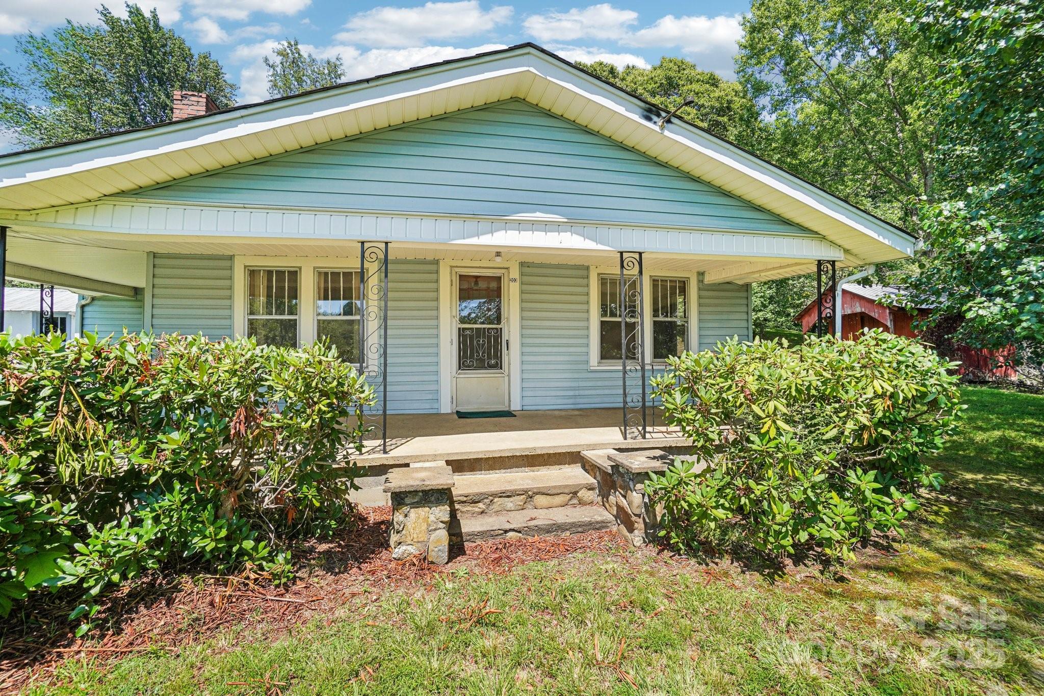 203 North Beaverdam Road Candler, NC 28715 - Photo 6 of 40 a front view of a house with garden