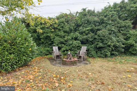 a view of a two chairs in a backyard