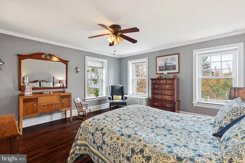 a bedroom with a bed dresser and a window