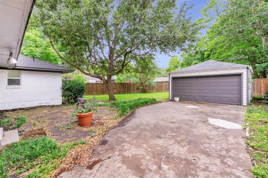 4815 Kelman Street Dallas, TX 75214 - Photo 37 of 37 Detached garage with a paneled door, offering dedicated parking and storage