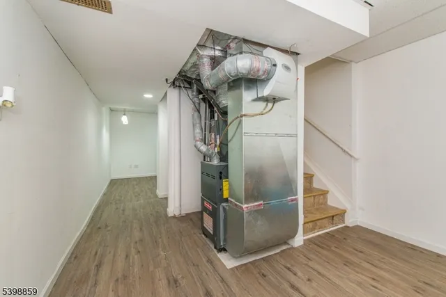 a view of hallway with wooden floor and stairs