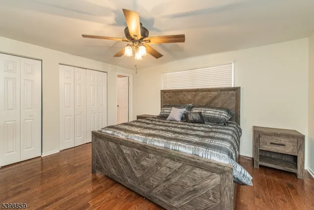 a bedroom with a bed and a ceiling fan
