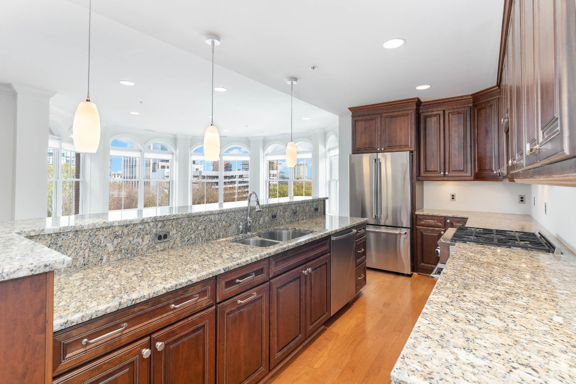 710 Independence Place, Unit 606 Raleigh, NC 27603 - Photo 1 of 21 a kitchen with stainless steel appliances granite countertop a sink refrigerator and cabinets