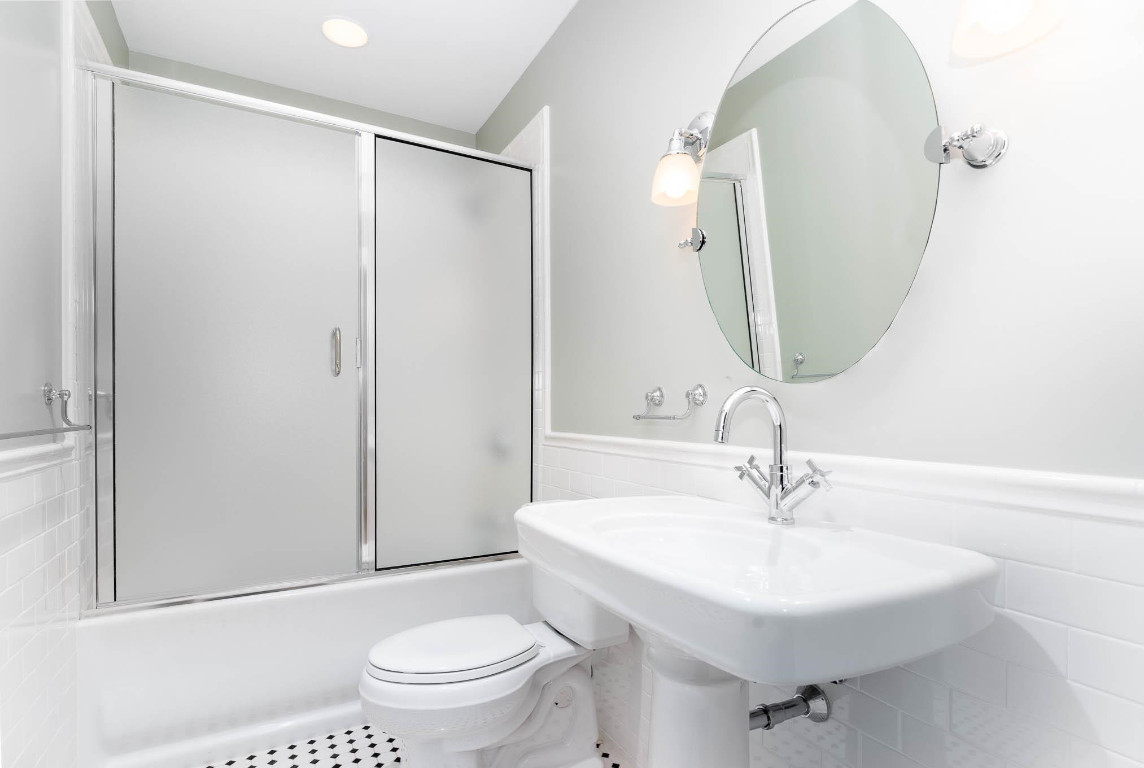 710 Independence Place, Unit 606 Raleigh, NC 27603 - Photo 14 of 21 a bathroom with a sink toilet and a mirror