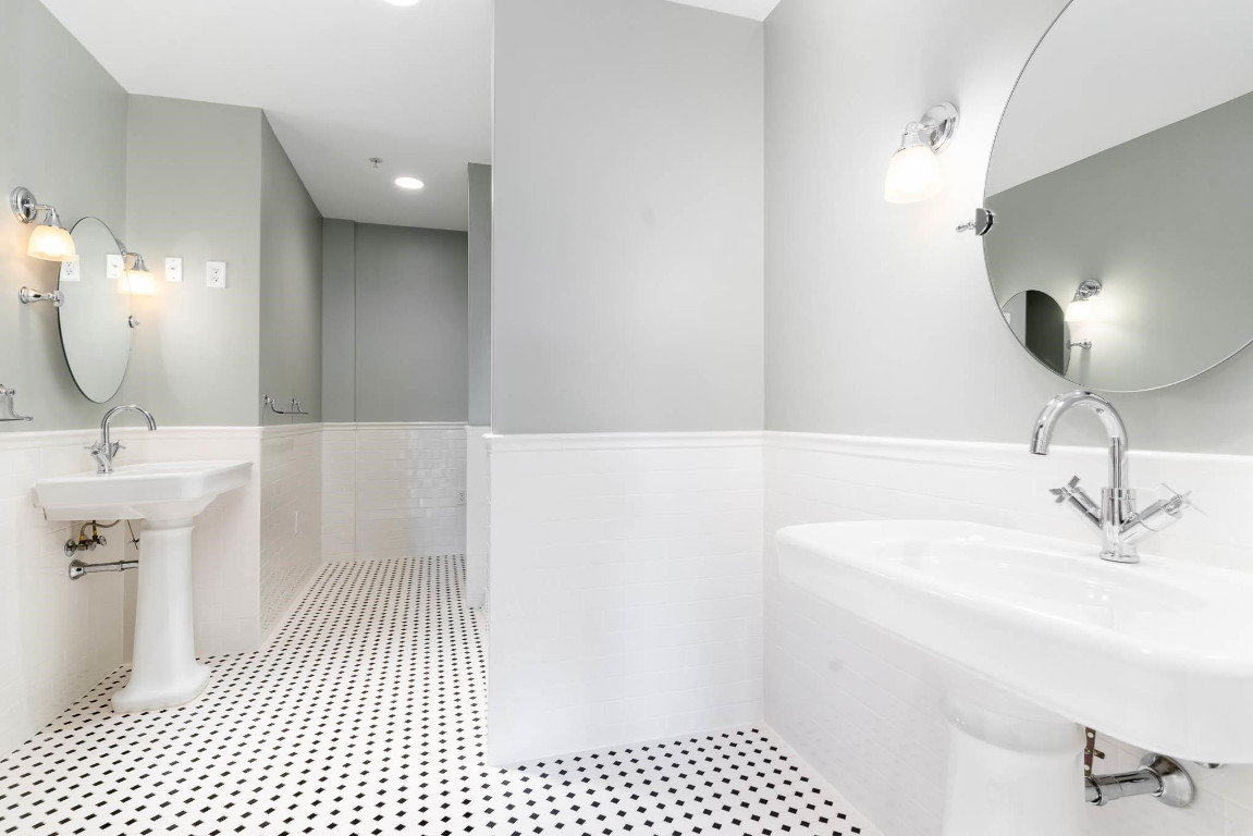 710 Independence Place, Unit 606 Raleigh, NC 27603 - Photo 15 of 21 a bathroom with a sink a toilet a mirror and shower