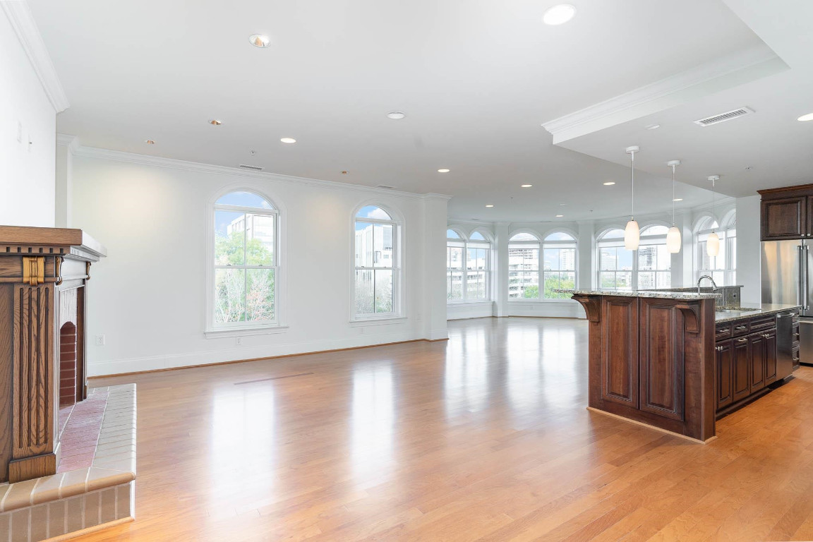 710 Independence Place, Unit 606 Raleigh, NC 27603 - Photo 4 of 21 a view of an empty room with wooden floor and a window