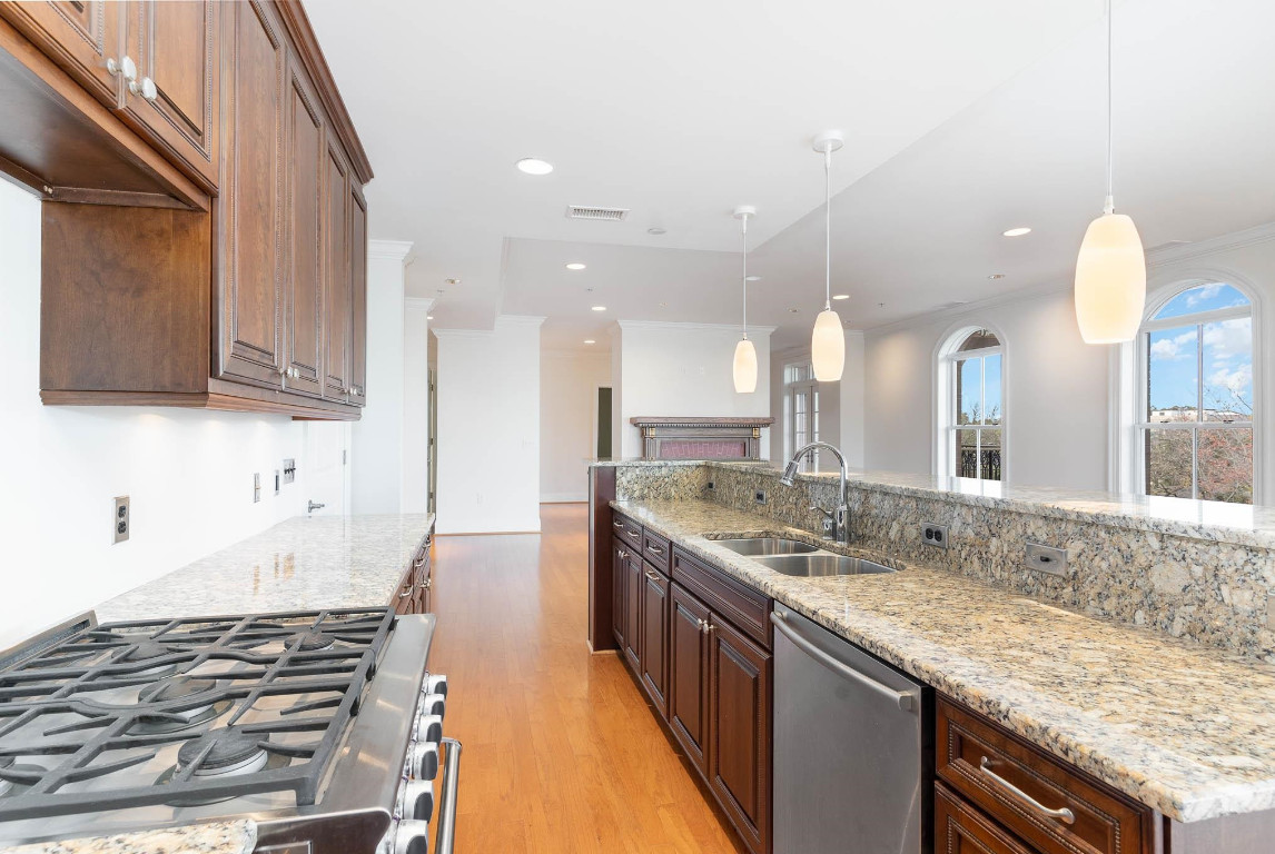 710 Independence Place, Unit 606 Raleigh, NC 27603 - Photo 6 of 21 a kitchen with a stove and a sink