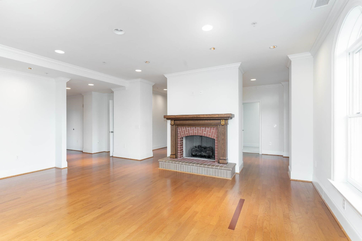710 Independence Place, Unit 606 Raleigh, NC 27603 - Photo 8 of 21 a view of an empty room with wooden floor fireplace and a window
