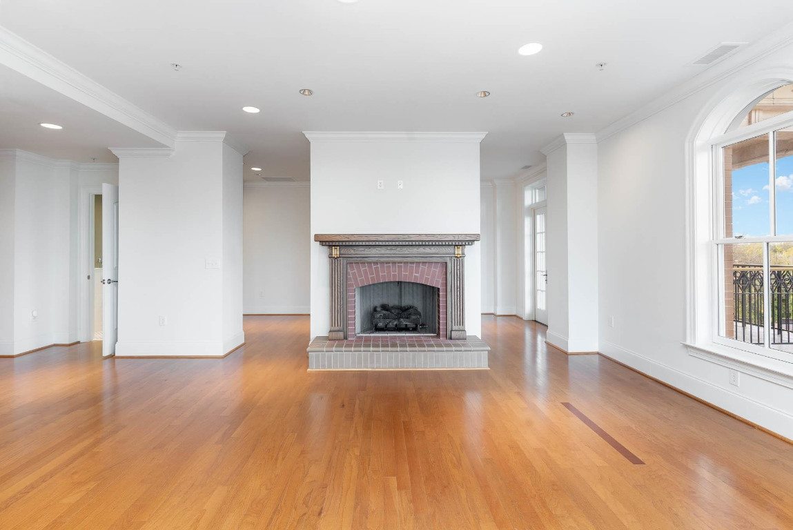 710 Independence Place, Unit 606 Raleigh, NC 27603 - Photo 9 of 21 a living room with a fireplace and wooden floor